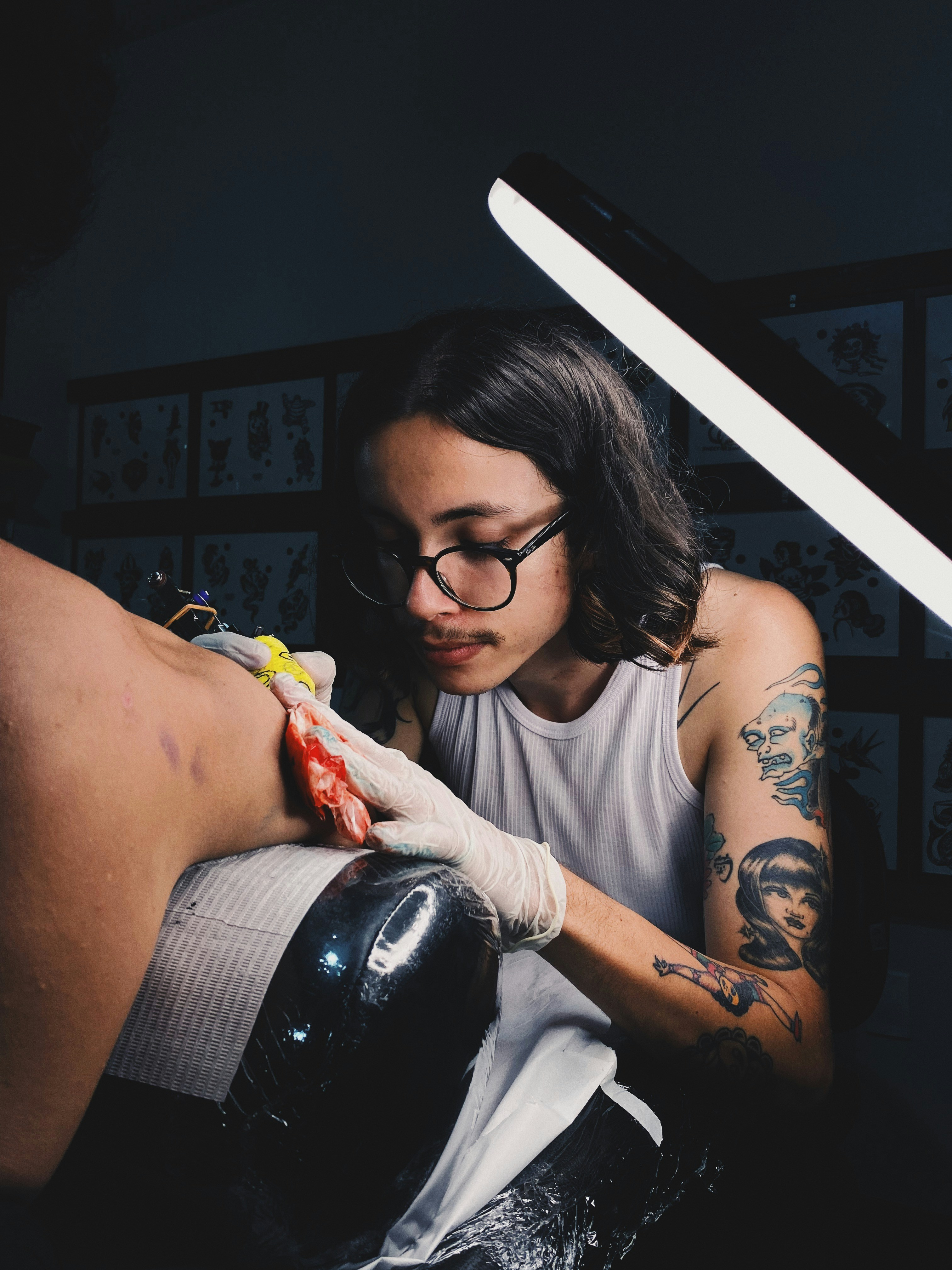 A Wame Ink artist working on a mandala piece in the studio.